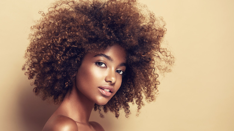 Woman with afro and glowing skin