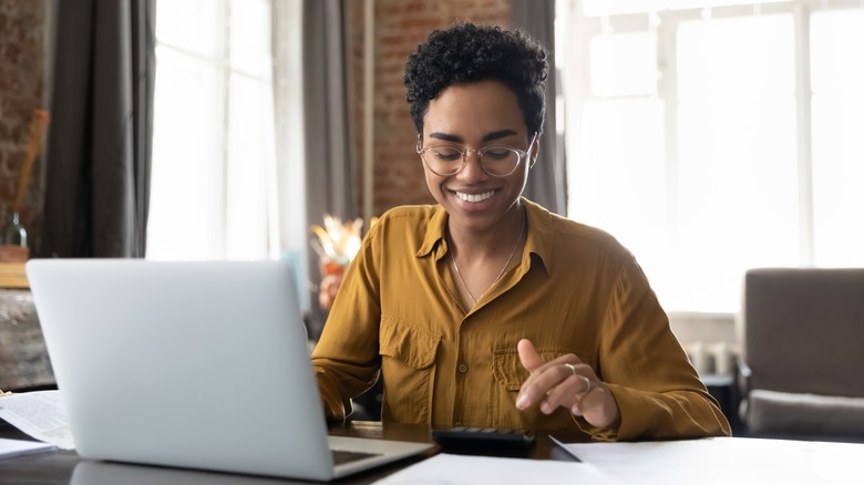 Woman working on a laptop at home