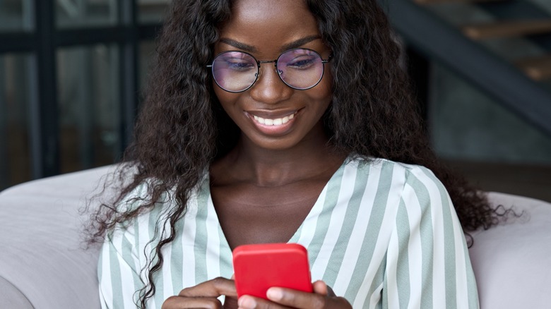 Woman smiling at her phone