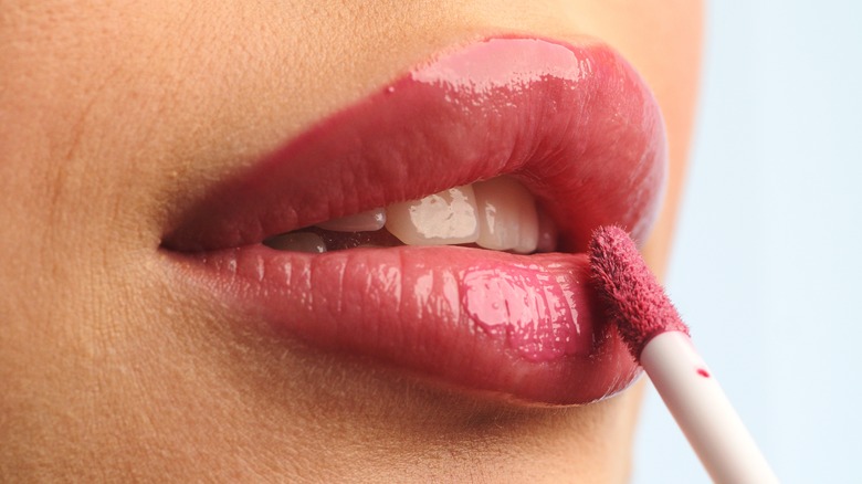 woman applying liquid lipstick