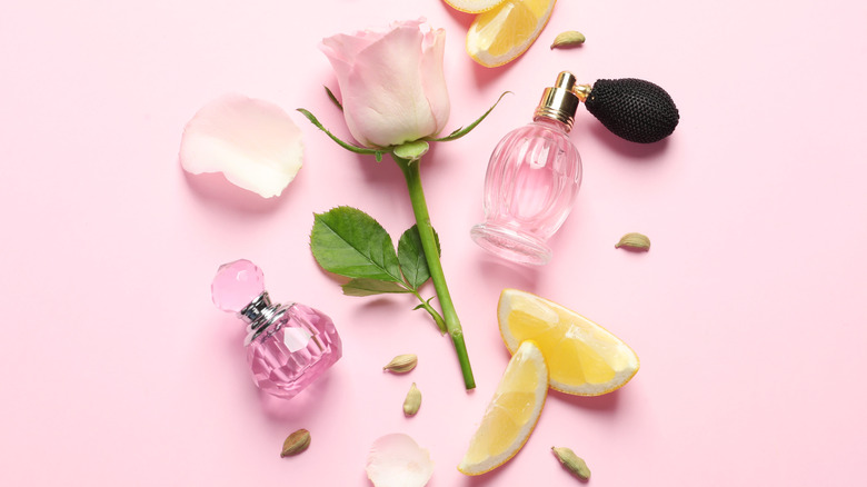 perfume bottles with lemons and petals 