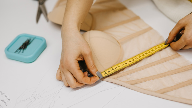 Woman measuring a corset top