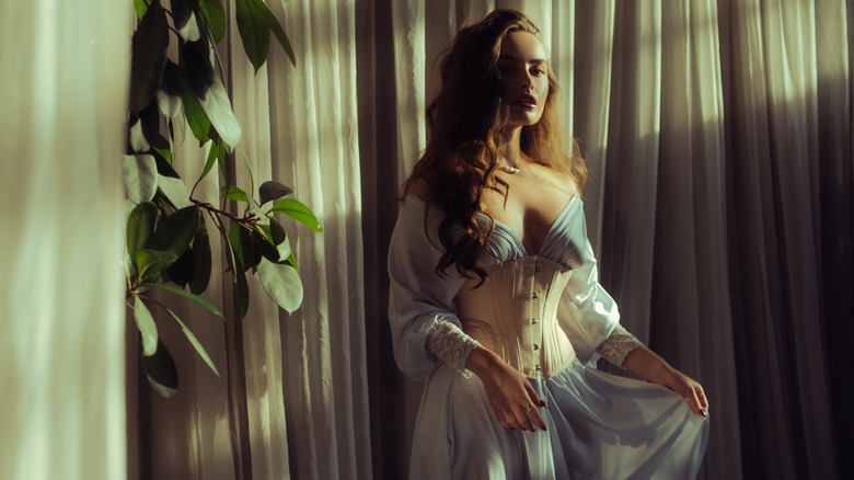 Woman wearing a dress and traditional corset 