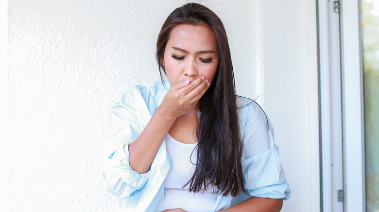 Woman experiencing nausea