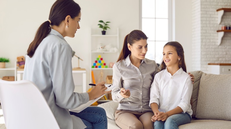 mother and daughter talking to therapist