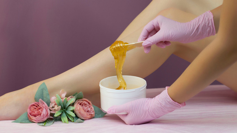 woman waxing legs