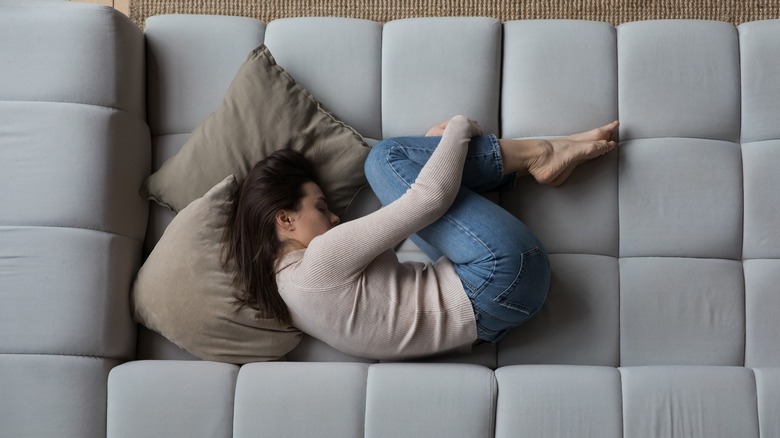 woman lying on couch