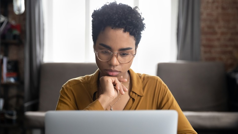 Woman looking at laptop