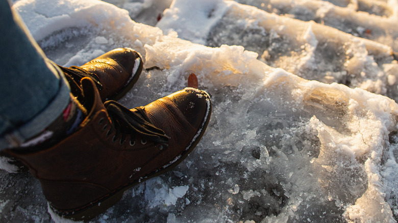 Woman in winter boots on snow and ice