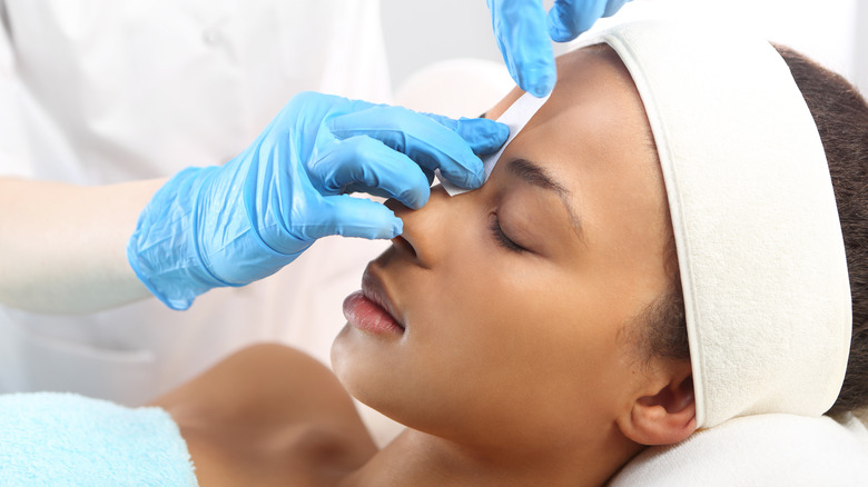 woman getting eyebrows waxed