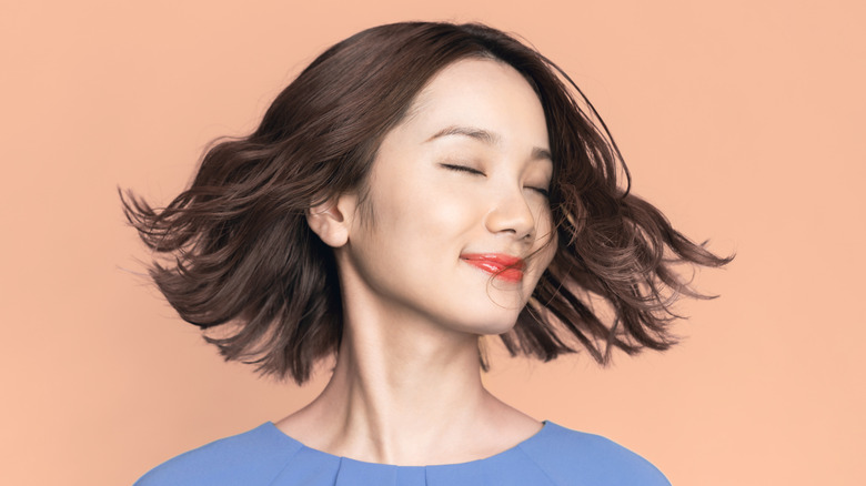 Woman showing off box bob haircut