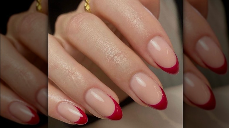 Closeup of nails with red french tip