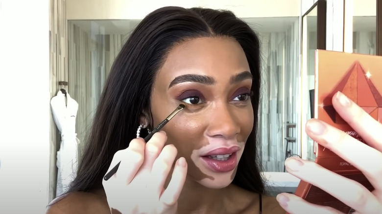 Winnie Harlow doing makeup 