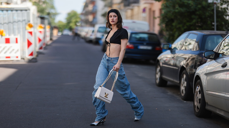 A woman posing in baggy jeans