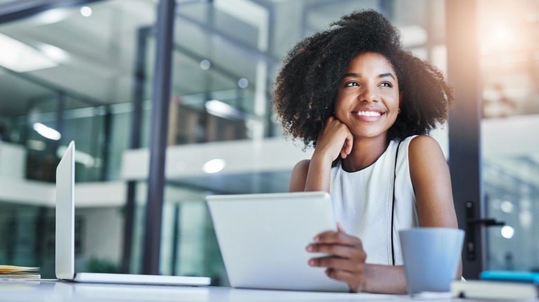 Woman smiles while working