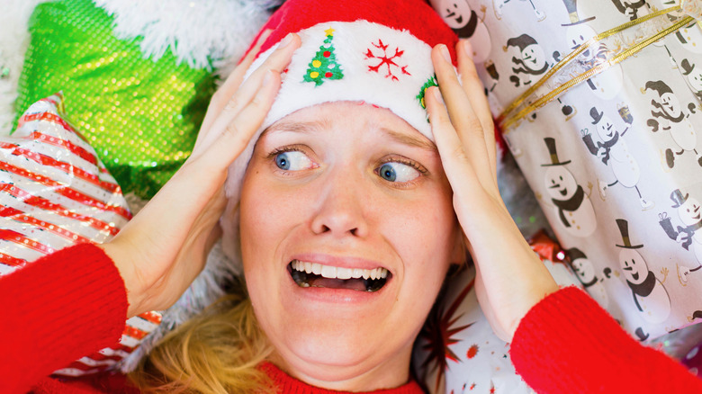 Overwhelmed woman in Christmas hat