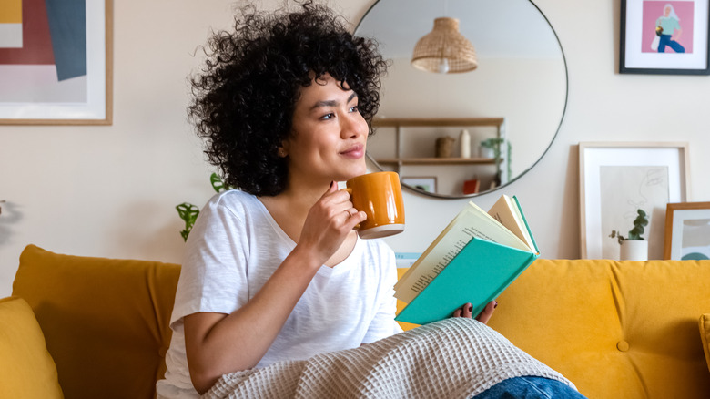 Woman enjoying coffee and book