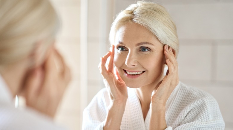 Gorgeous older woman looking in mirror