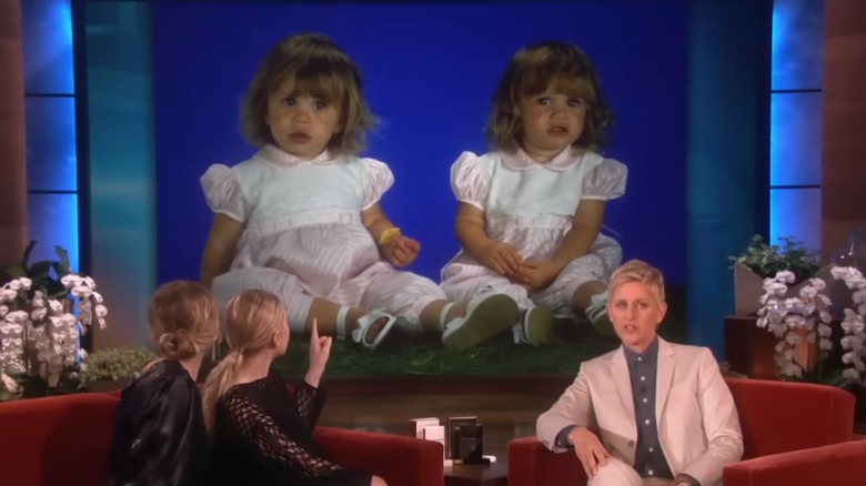 Mary-Kate and Ashley Olsen look at old photos of themselves