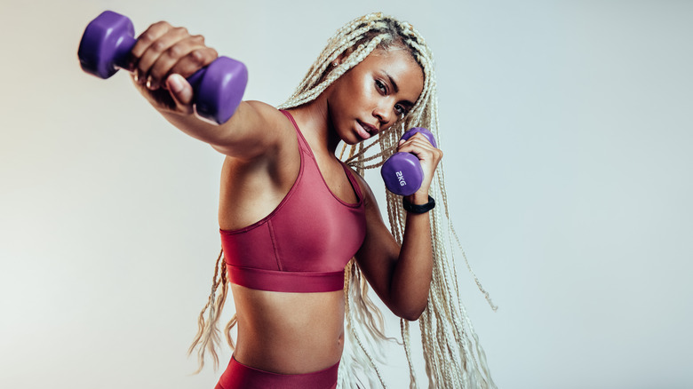 A woman exercising with a 2kg weight