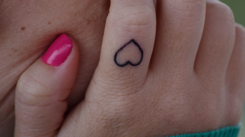 heart tattoo on woman's finger