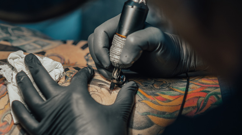 A tattoo artist at work 