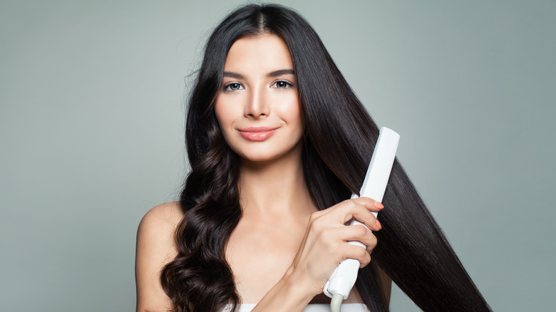 Woman using flat iron