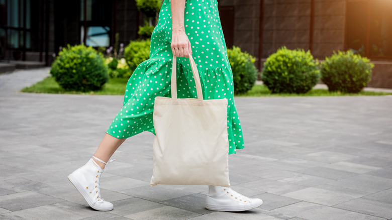 Woman carrying canvas tote bag