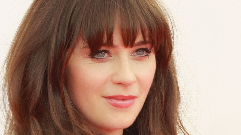 Zooey Deschanel grinning with bangs