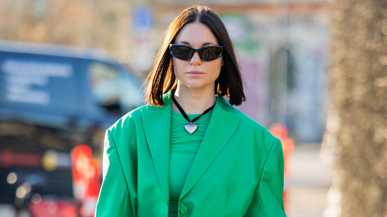 cord necklace with green blazer 