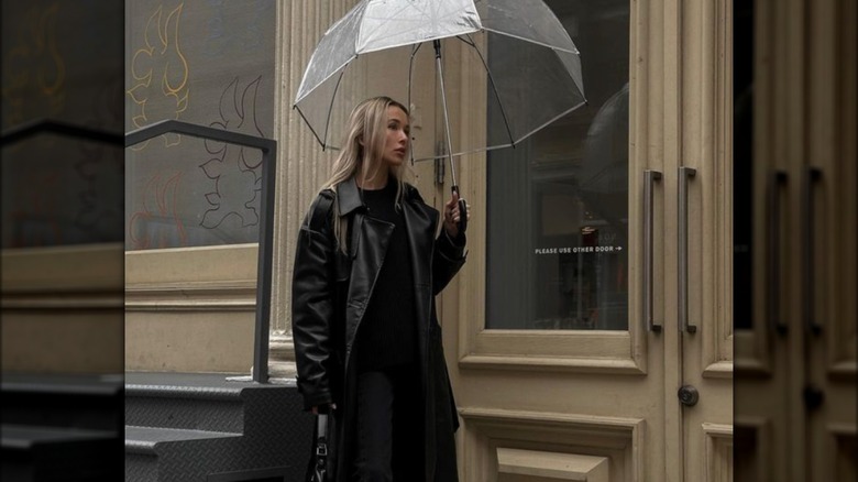 Woman in black with umbrella