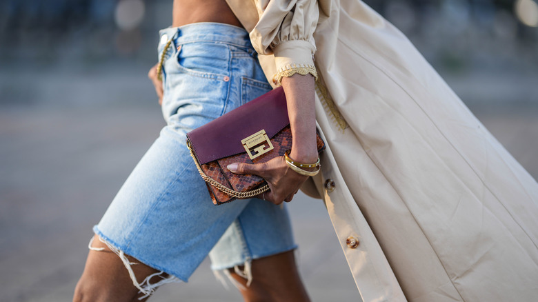 Woman walking, wearing denim shorts