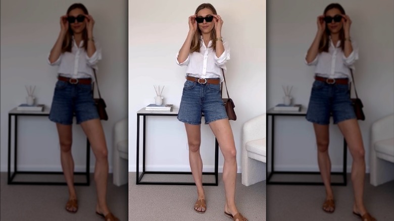 Tori Jane wearing white button-down top and denim shorts