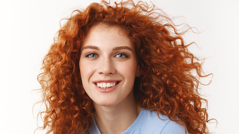 a woman with long curly hair 