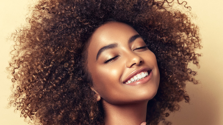 Woman with curly hair smiling