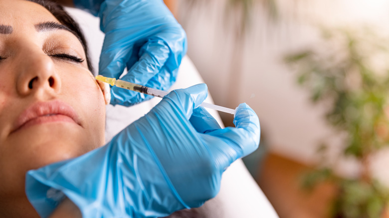 woman receiving injections in her cheek