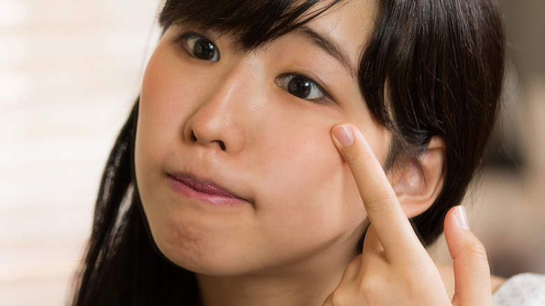 Woman checking her face