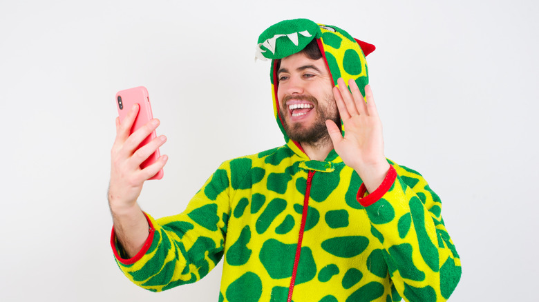 man wearing dinosaur onesie costume