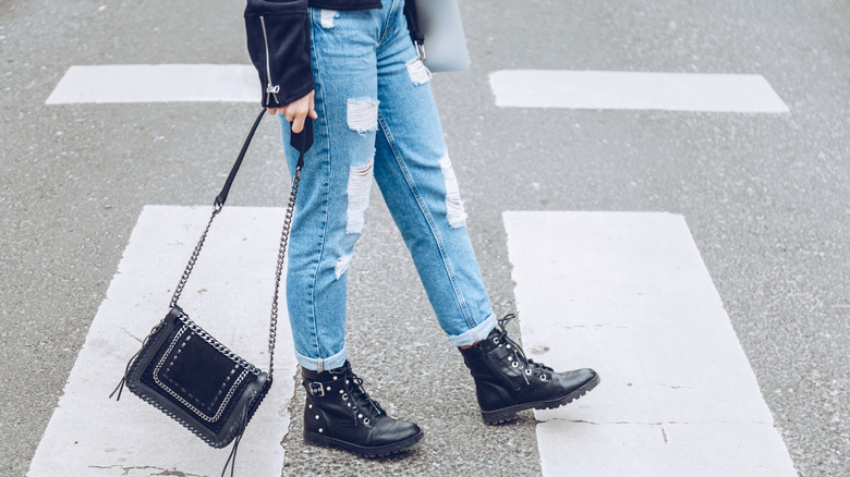 woman with distressed jeans walking