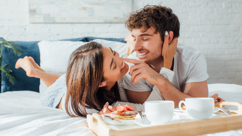 Two people have coffee in bed 