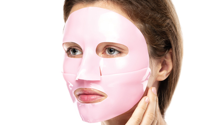 young woman wearing pink rubber face mask