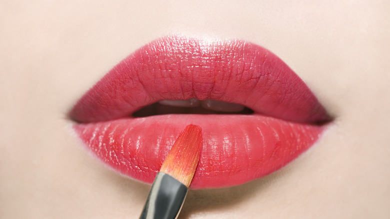 Lip brush on pink-red lips