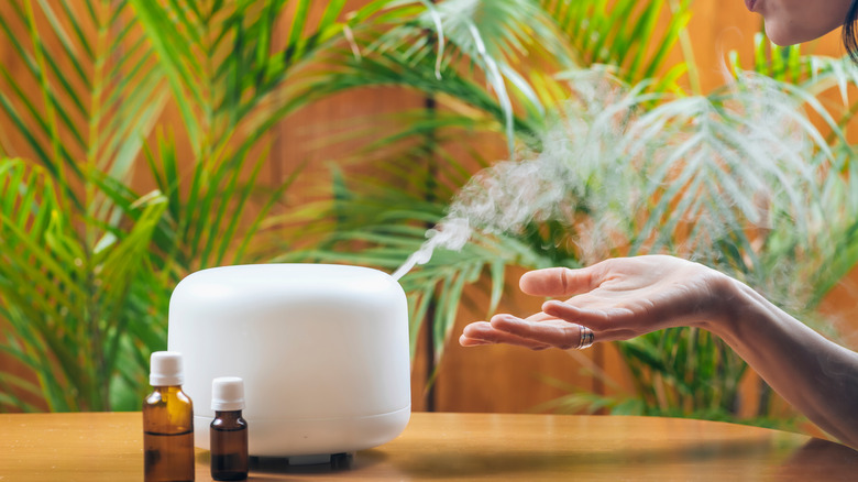 Woman diffusing an essential oil 