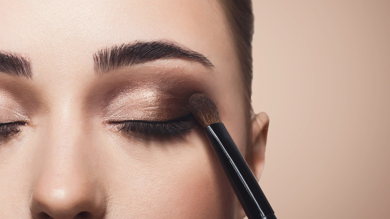 Woman applying eyeshadow