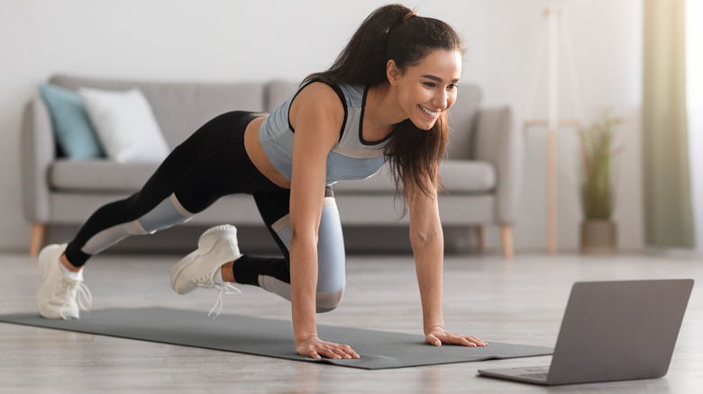 Young woman exercising on the floor