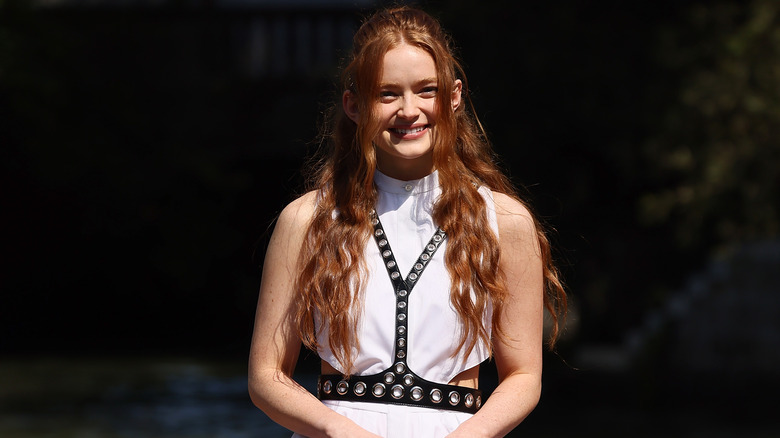 Sadie Sink wearing black leather harness