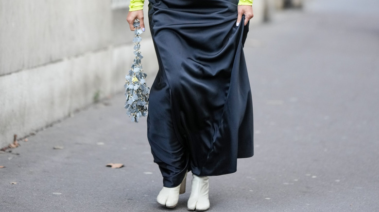 woman walking in black maxi skirt