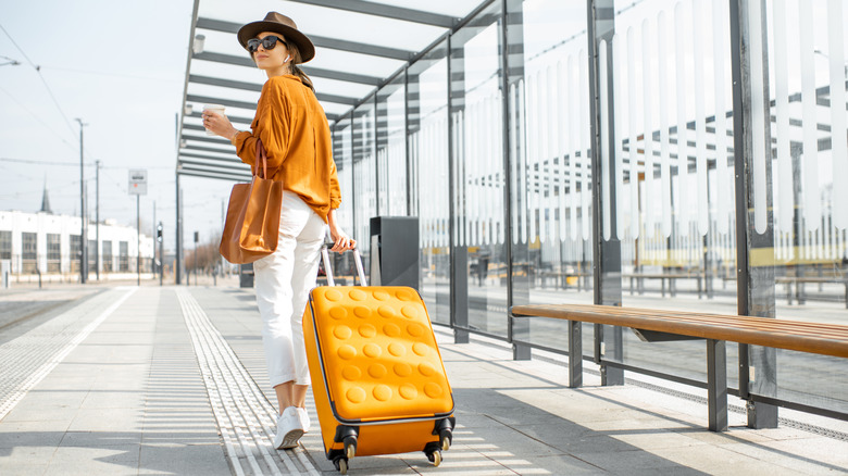 Young woman carrying her luggage