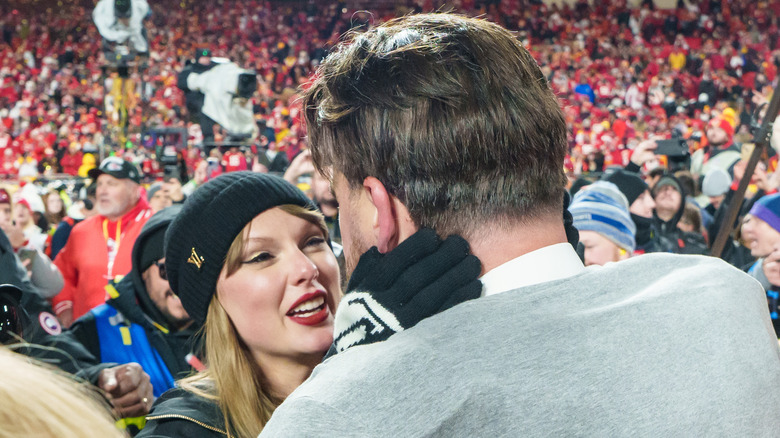 Taylor Swift smiling at Travis Kelce