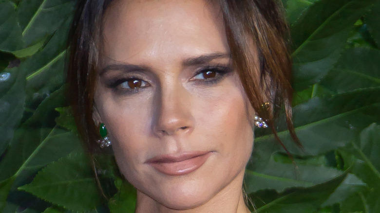 Victoria Beckham in smoky eyeshadow look posing at event